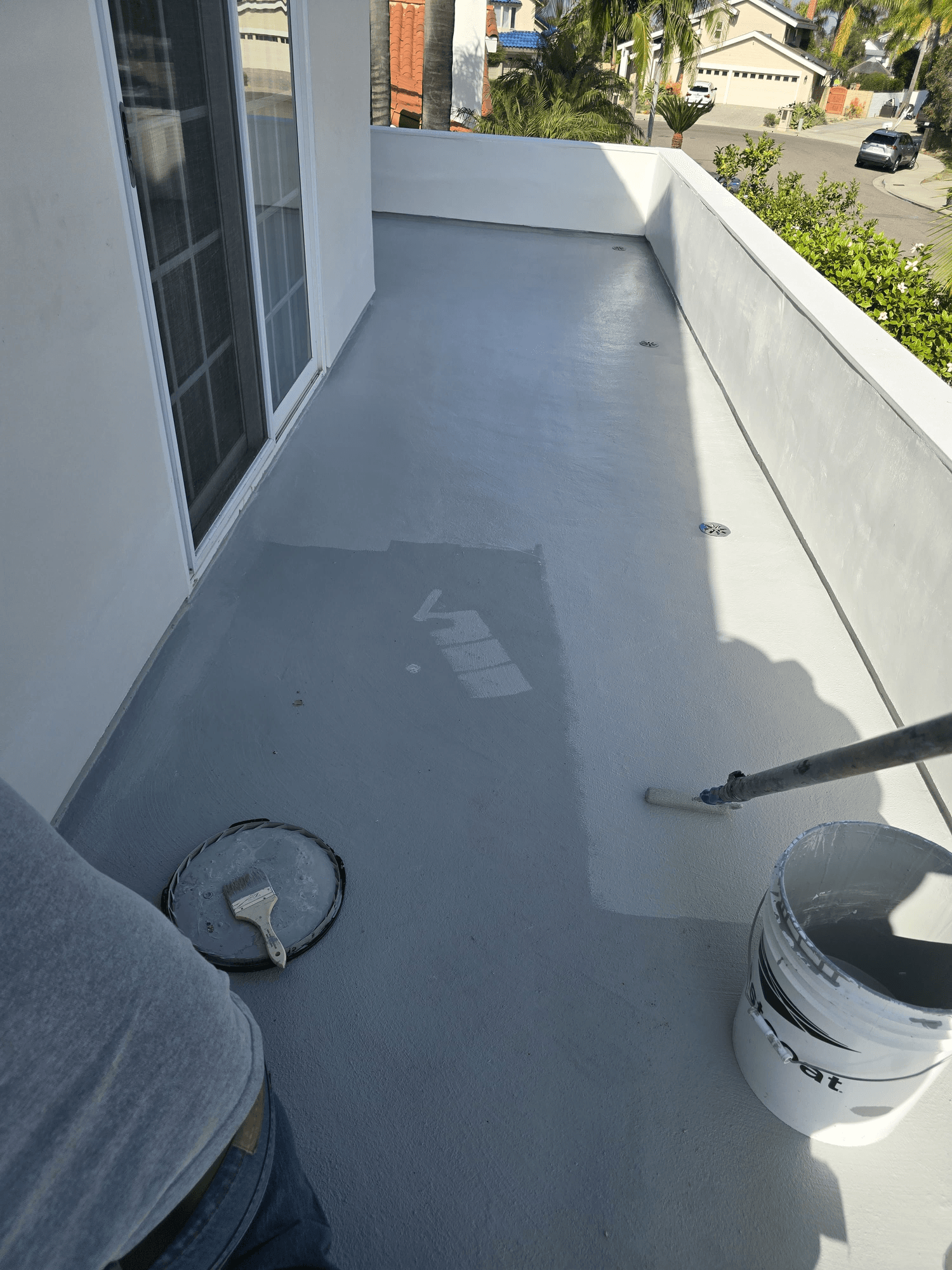 Waterproof deck coating in progress, residential balcony