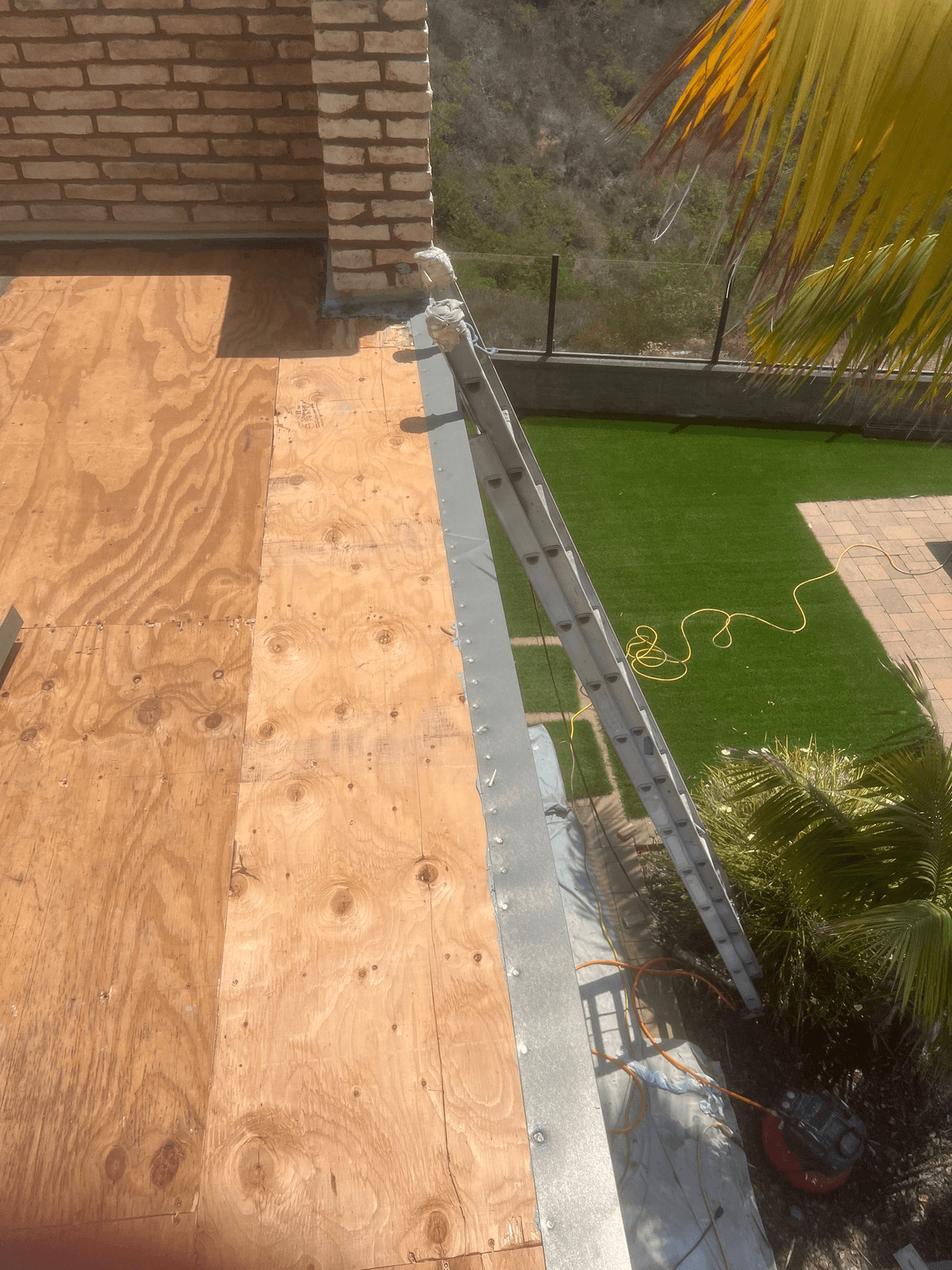 Deck plywood subfloor and metal flashing in preparation